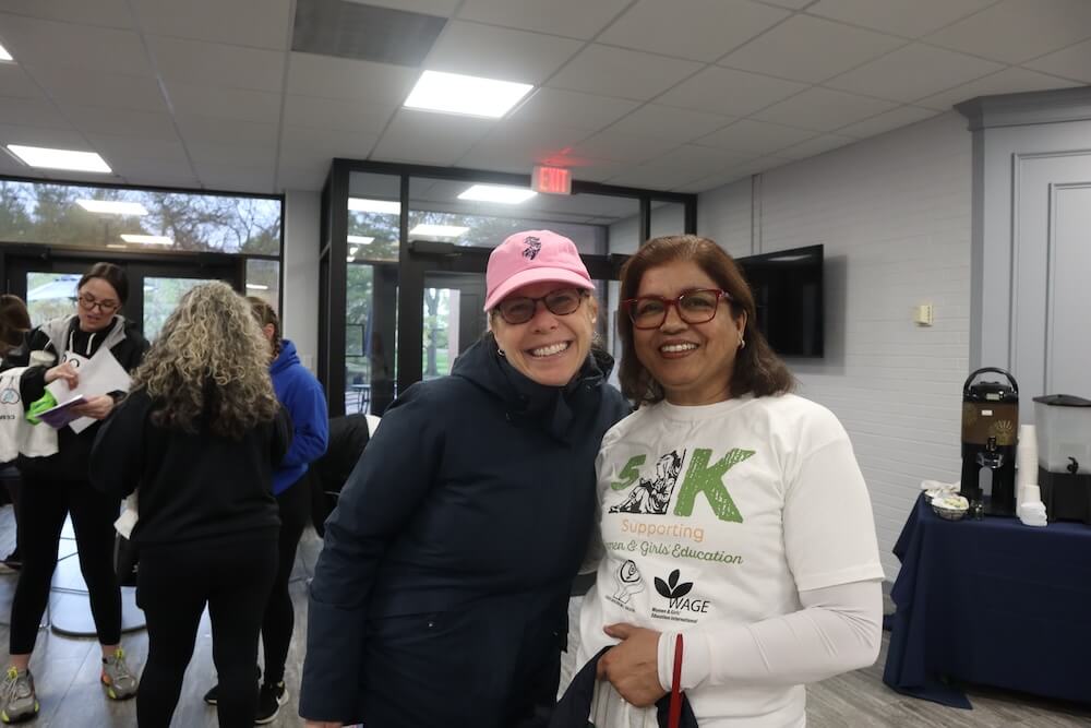 Two women smiling for camera, one wearing a 5k shirt.