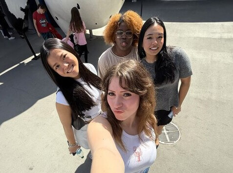 Four women taking a selfie.