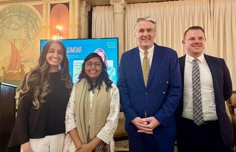 Megha Majumdar standing beside University President Patrick F. Leahy and two others