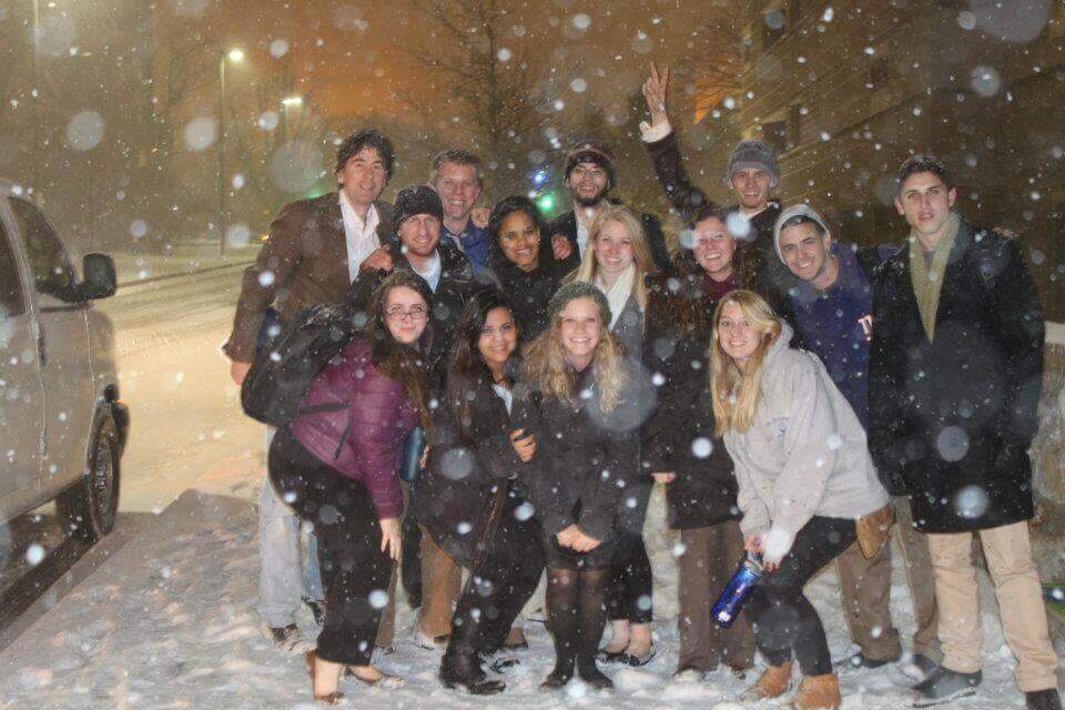 Group of people posing for photo in the snow