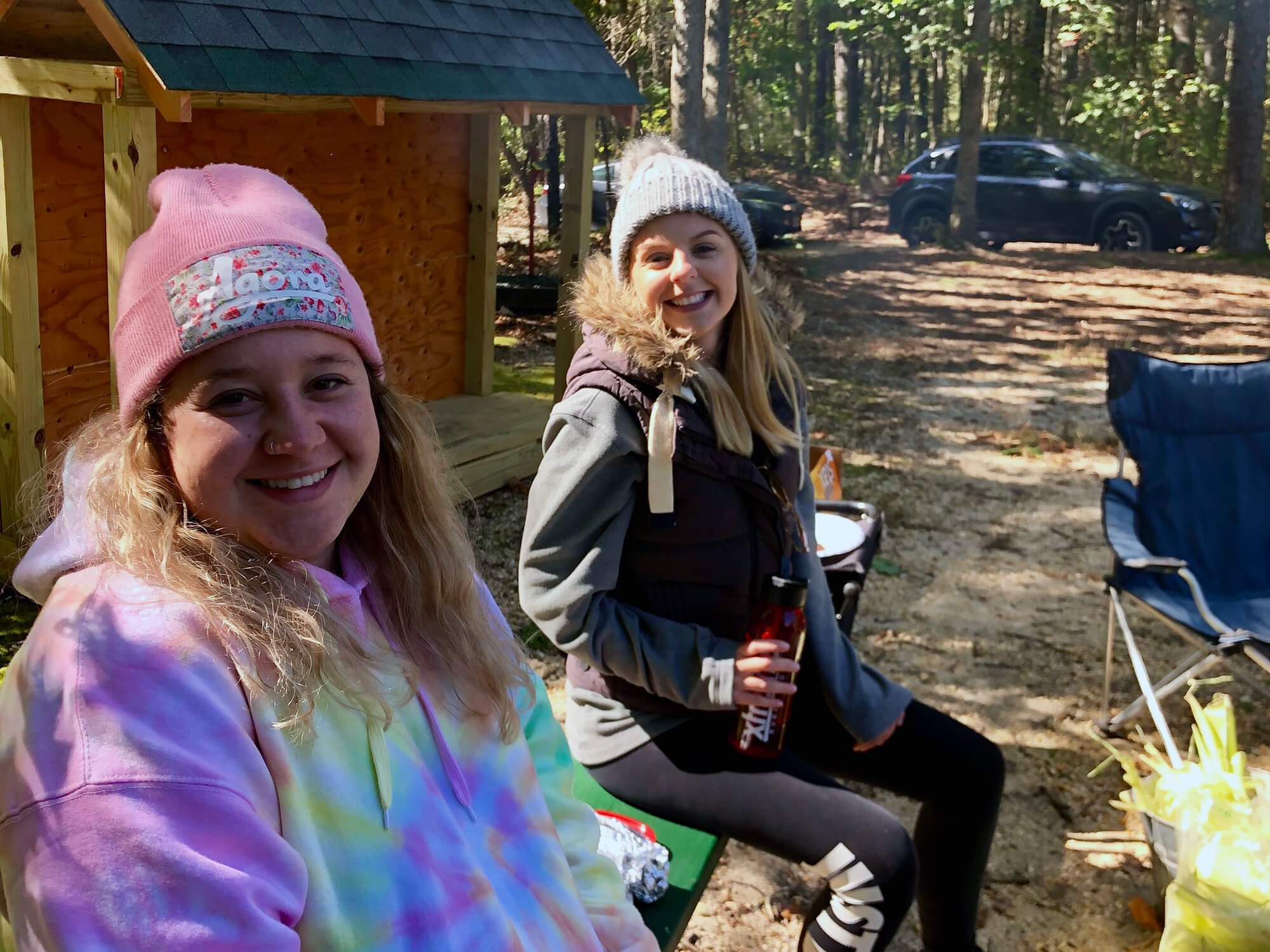 Photo of two Ecotherapy Students taking a break during their field trip