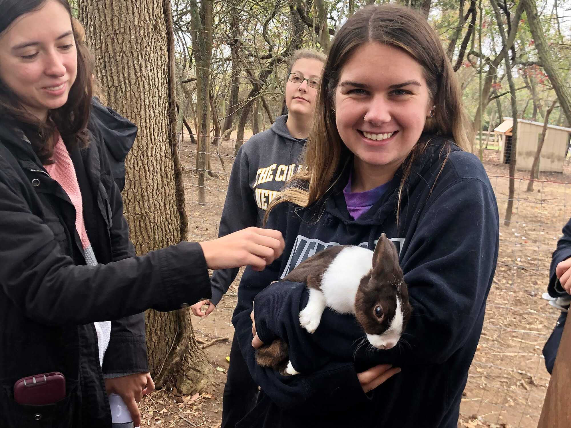 Photo of students holding a rabbit