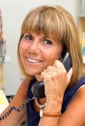 Francine Swift holding a landline phone to her ear