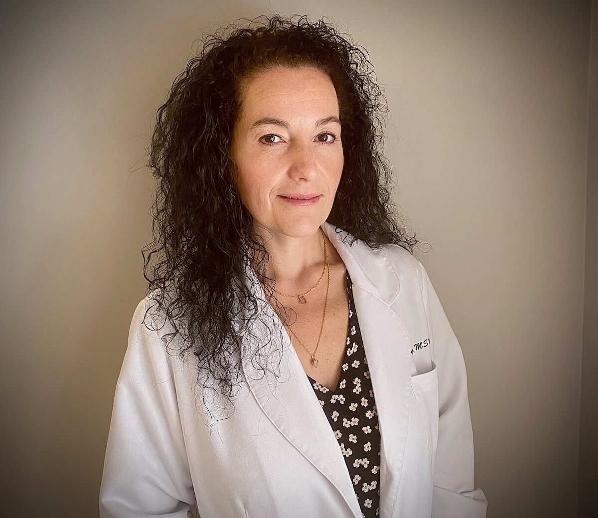 Headshot of Margie Prejs in her white coat