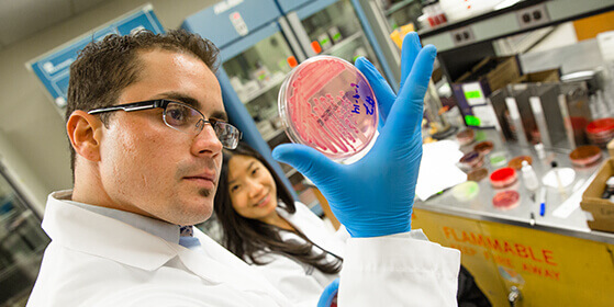 student holding a petri dish