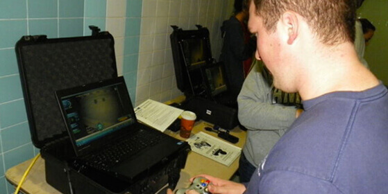 Man using a laptop to control a Remote Operated Underwater Vehicle