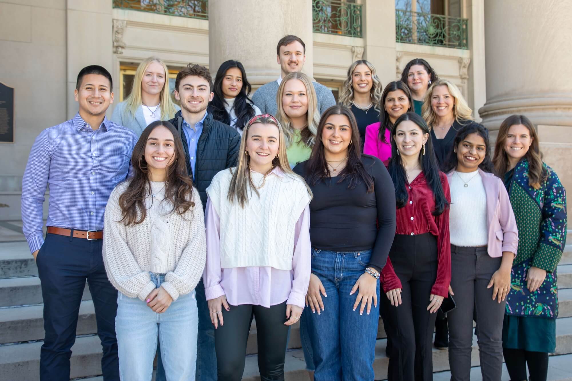 Members of the Global Education Office standing on the steps of the Great Hall
