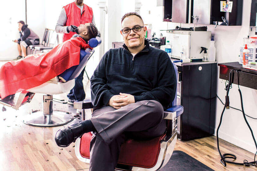 Man sitting inside a barber shop