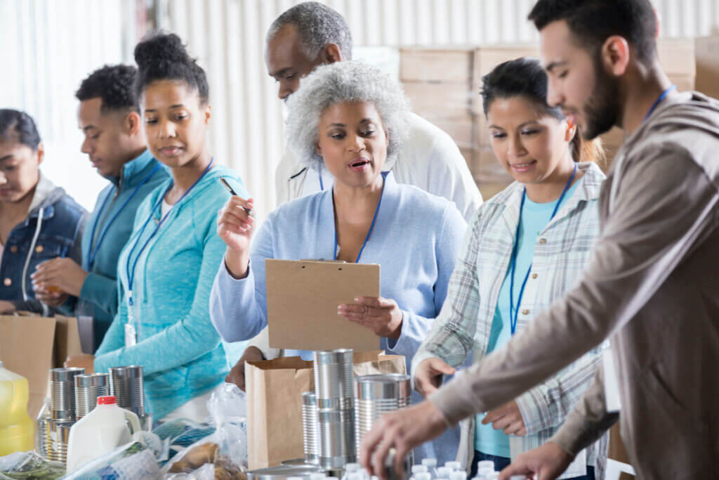 Food bank manager instructs volunteers