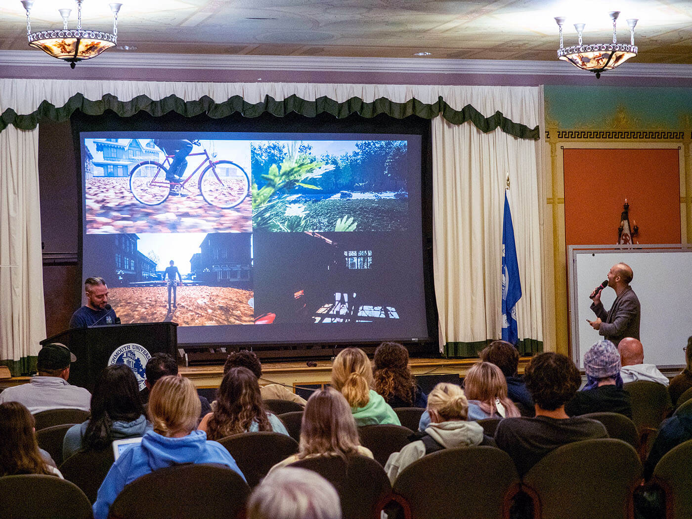 A man is talking about images projected onto a screen in front of an audience