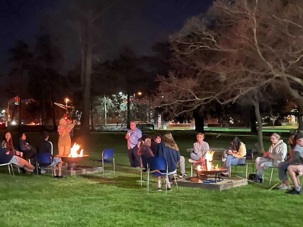 groups of students around two fire pits