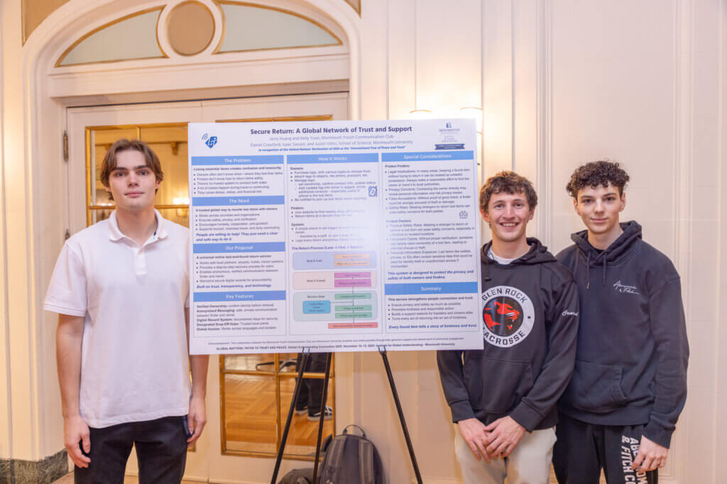 Three students with a research poster