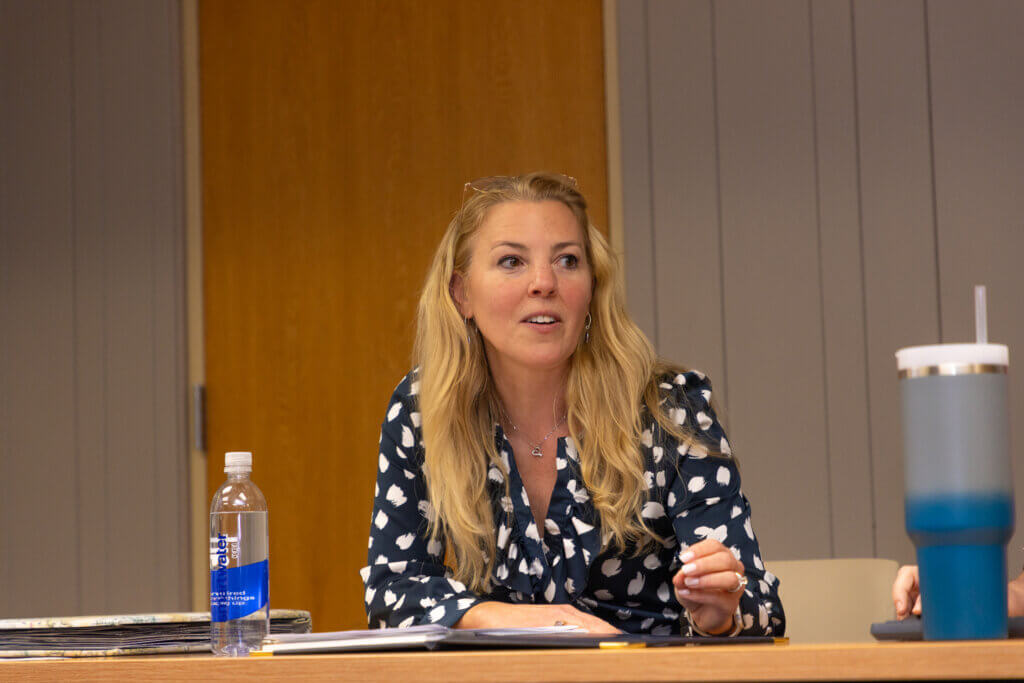 A seated attendee speaking