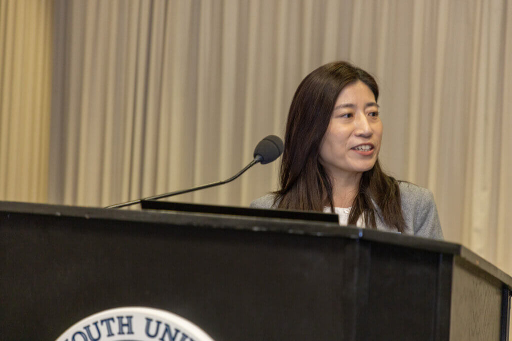 A speaker behind a lectern