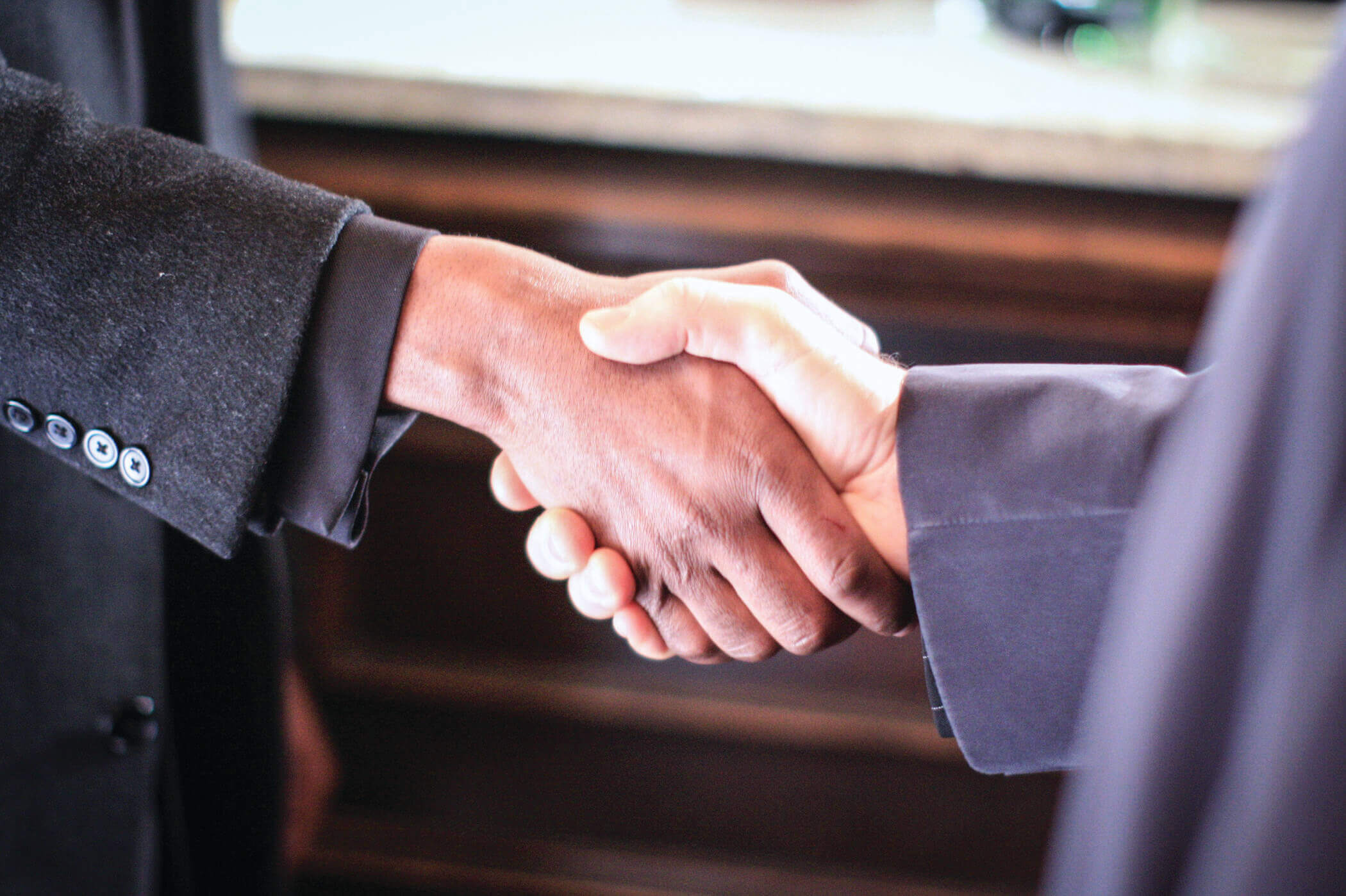 Close-up shot of two hands shaking.