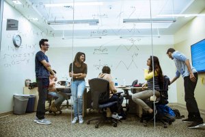 Students laughing inside one of the School of Science Building's conference rooms