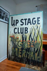 Springsteen met several future members of the E Street Band while playing at the Upstage Club, a now defunct music venue and coffeehouse (Green Mermaid Café) that was located in Asbury Park, New Jersey. The piano behind the sign belonged to Southside Johnny, another frequent Upstage performer.