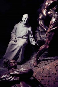 Sculpture of a man in a Benedictine monk's habit