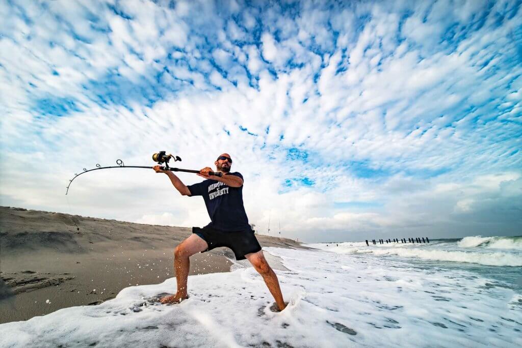 Assistant Professor Keith Dunton casts a line into the Atlantic in hopes of hooking a shark.