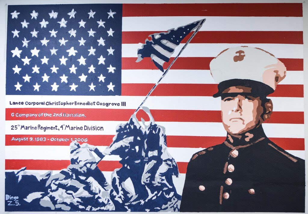 Mural of Lance Cpl. Christopher Cosgrove III ’05, with the American Flag and the raising of the flag on Iwo Jima in the background.