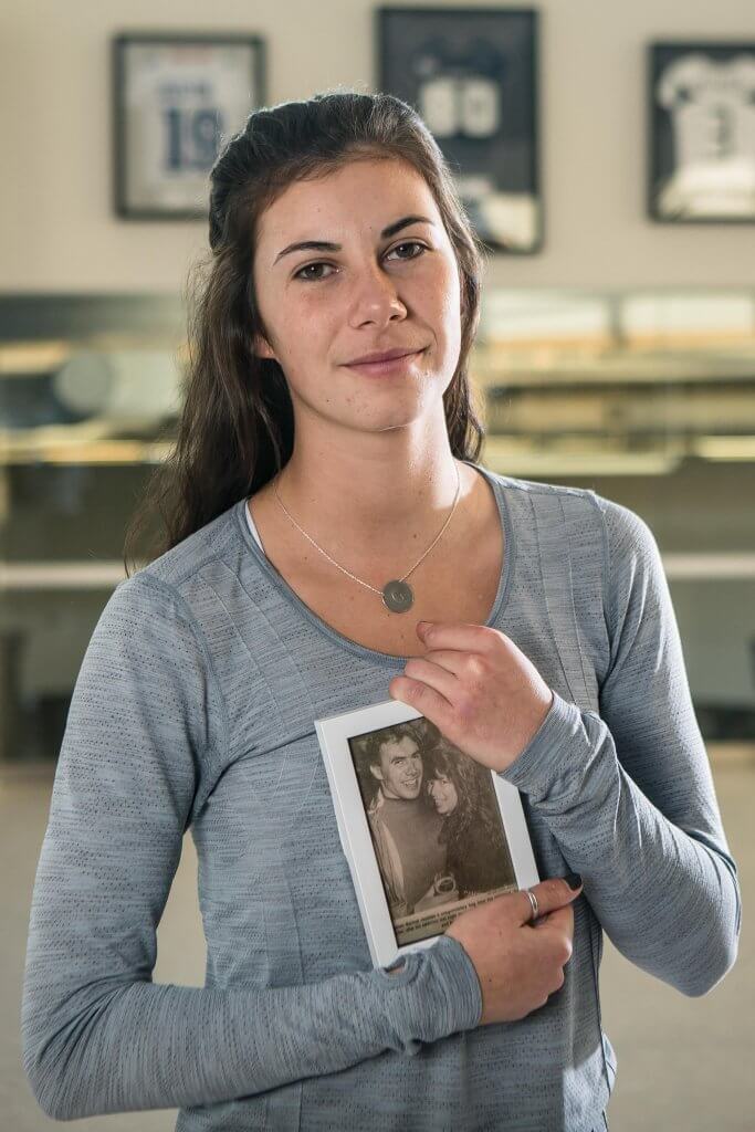 Georgia Garden Bachor holding a framed photograph of her parents