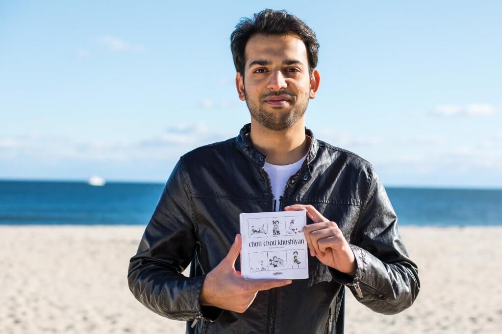 Hamza Zafar holding the book Choti Choti Khushiyan, a farewell gift from friends in his home country of Pakistan