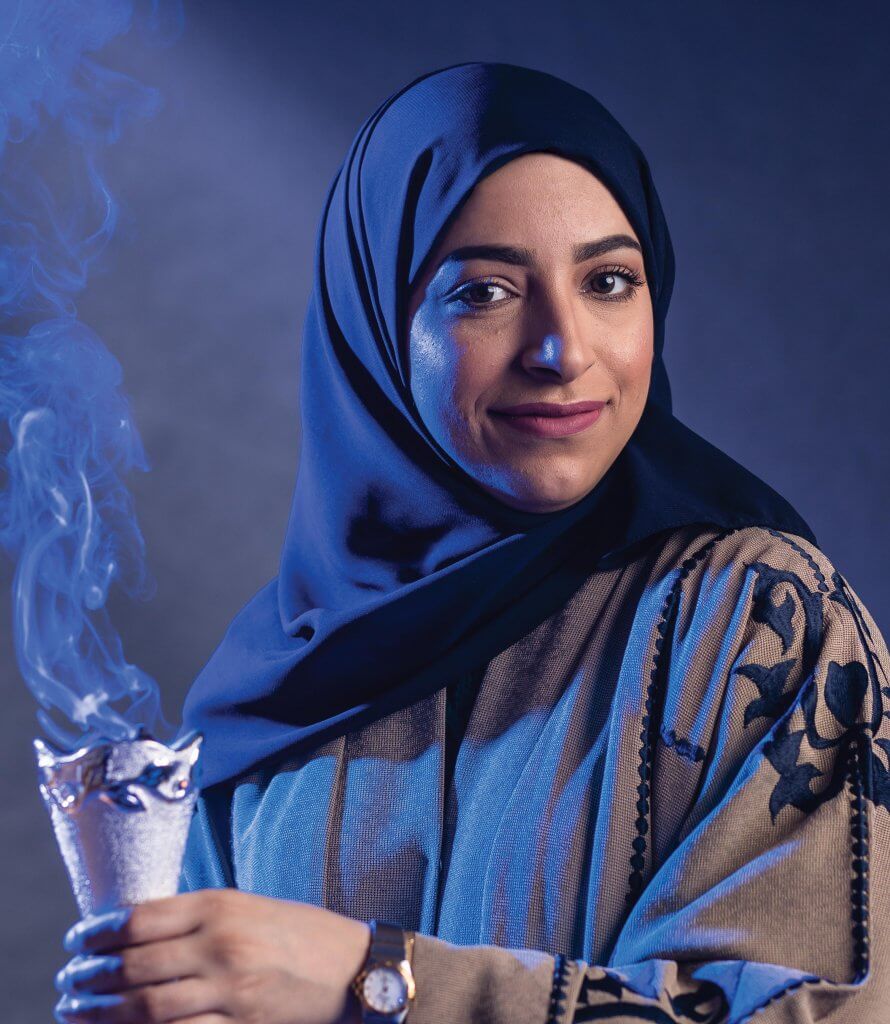 Sarah Almuhaish burning incense in a censer