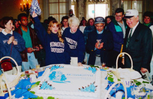 A group of people celebrating University Day 1995, when Monmouth became a University