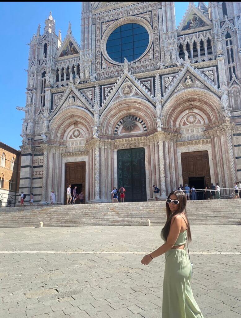 a young woman outside the Siena Cathedral