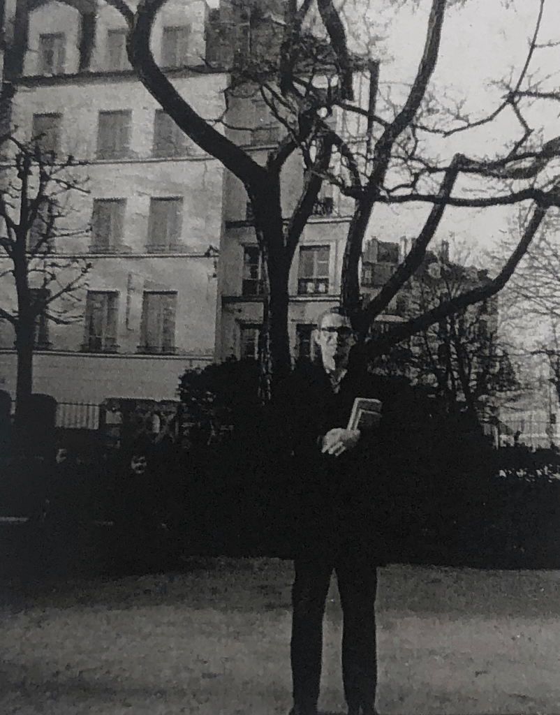 a B&W photo of a man on a Paris street