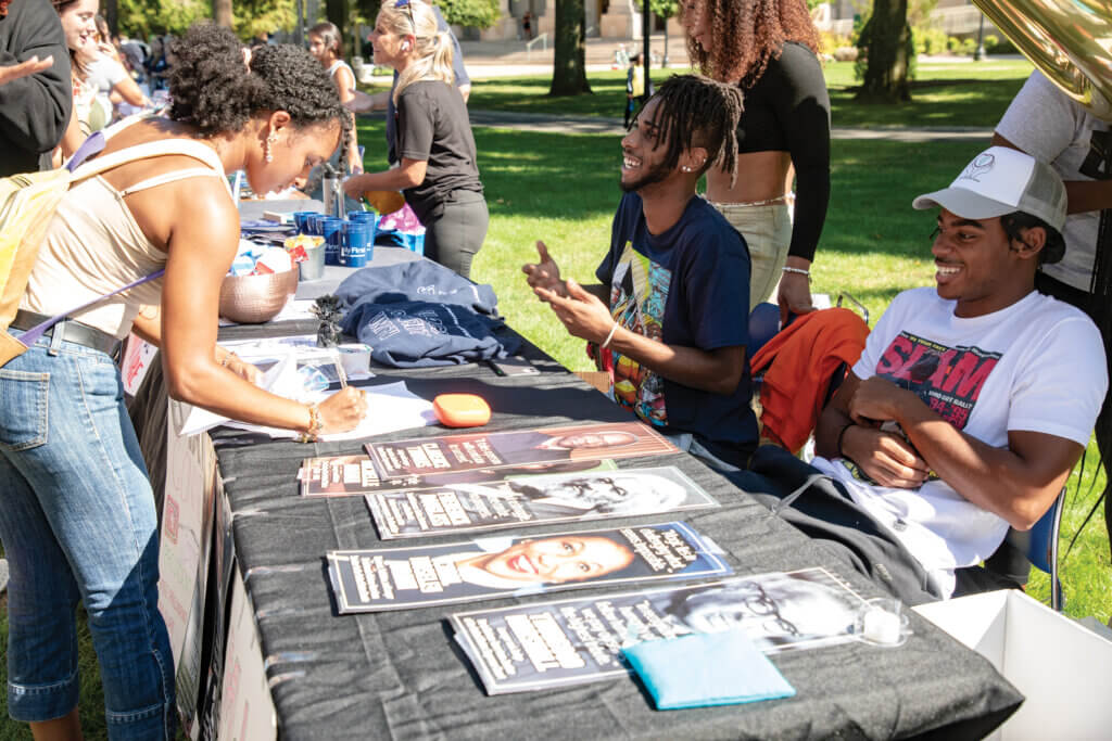 Students at an information table during the Involvement Fair