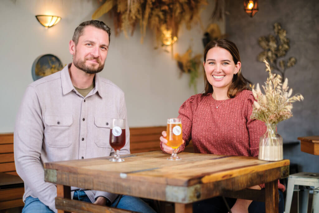 A photo of alumna Chelsey DeMarino Ziolkowski and her husband, Michal Ziolkowski enjoying a beer in their brewery, Bradley Brew Project. 