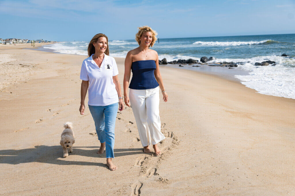 Living as a survivor, Alayna enjoys a warm sunny day on a beach walk with her mom, Elaine, and dog, Daisy.