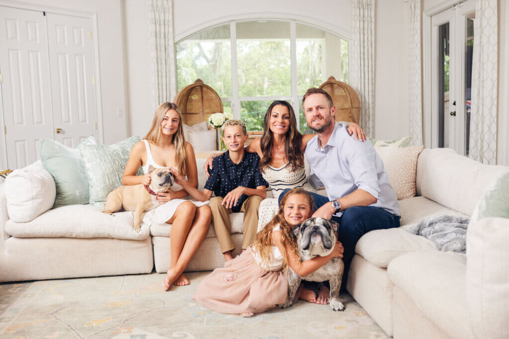 Stephenie LaGrossa Kendrick sitting with her husband Kyle Kendrick and their children—Sophie, 14; Kyle Jr., 12; and Sloane, 7—and their Frenchie, Kona, and bulldog, Bam Bam.