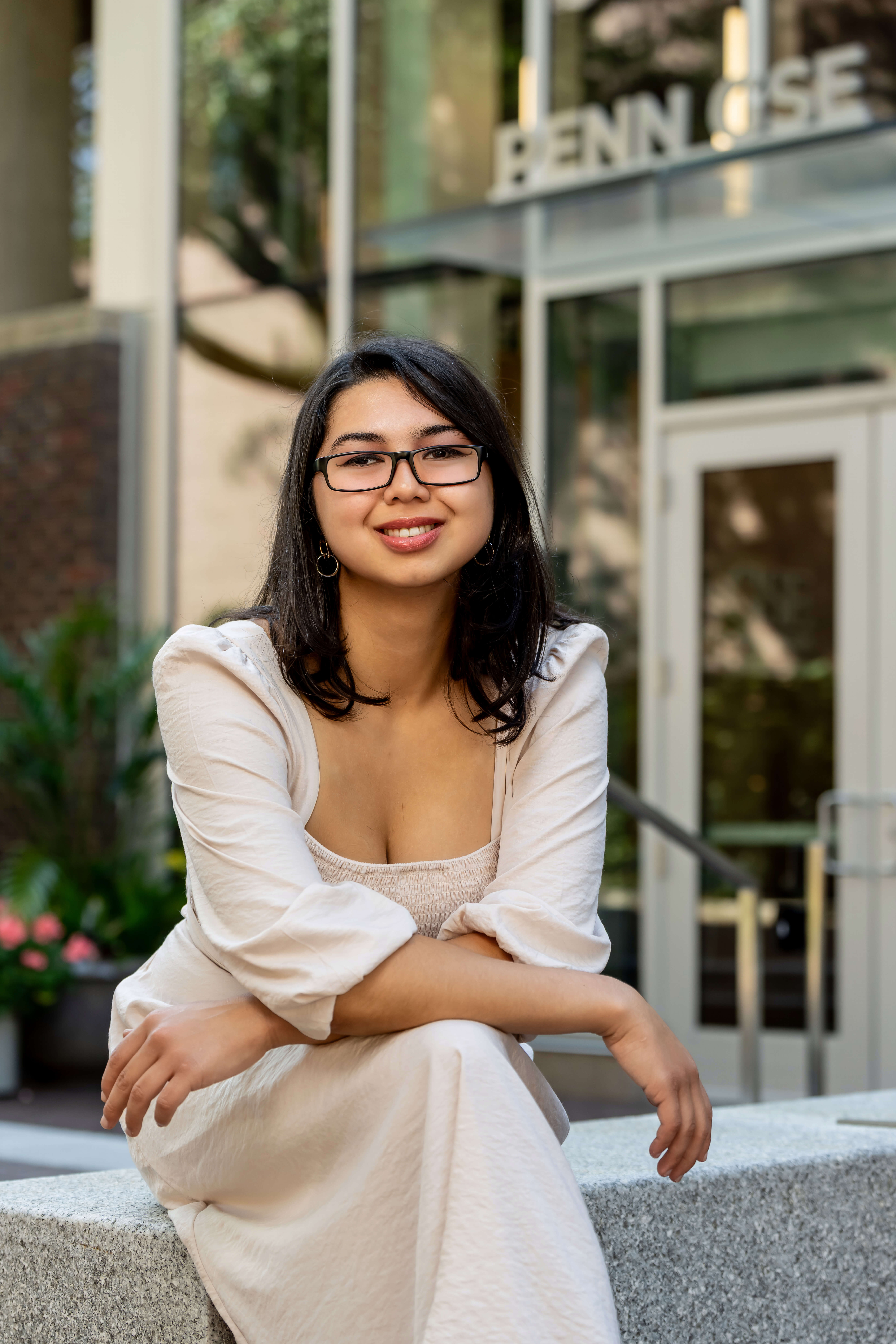 A photo of Ashley Zingillioglu ’25 sitting posed on the University of Pennsylvania campus.