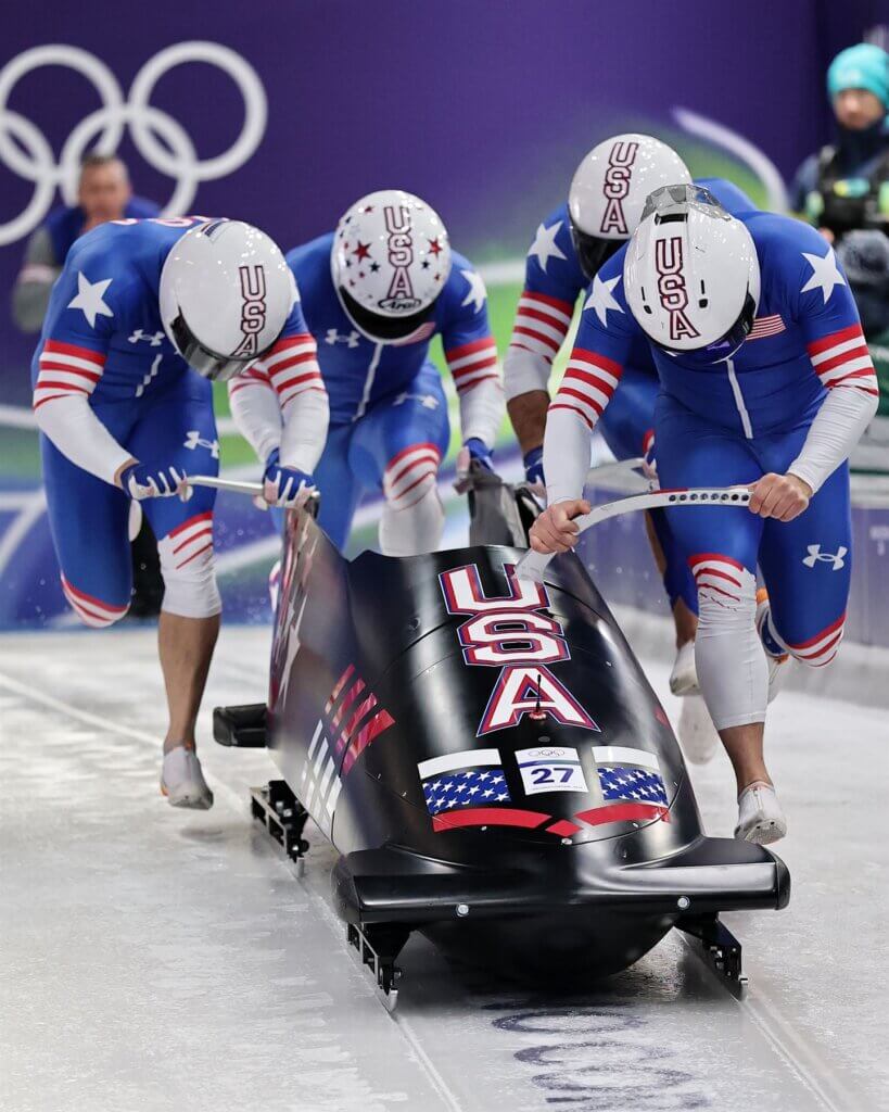 Bryan Sosoo pushes a Team USA four-man bobsled during competition at the 2026 Winter Olympics in Cortina, Italy.