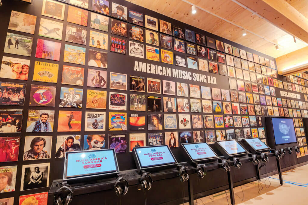 The interactive American Music Song Bar at the Bruce Springsteen Center for American Music features album covers, touch screens, and listening stations