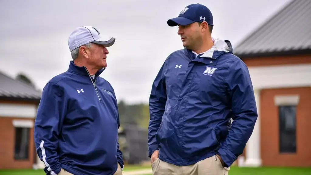 Kevin Callahan and Jeff Gallo talking on the field before a Monmouth football game