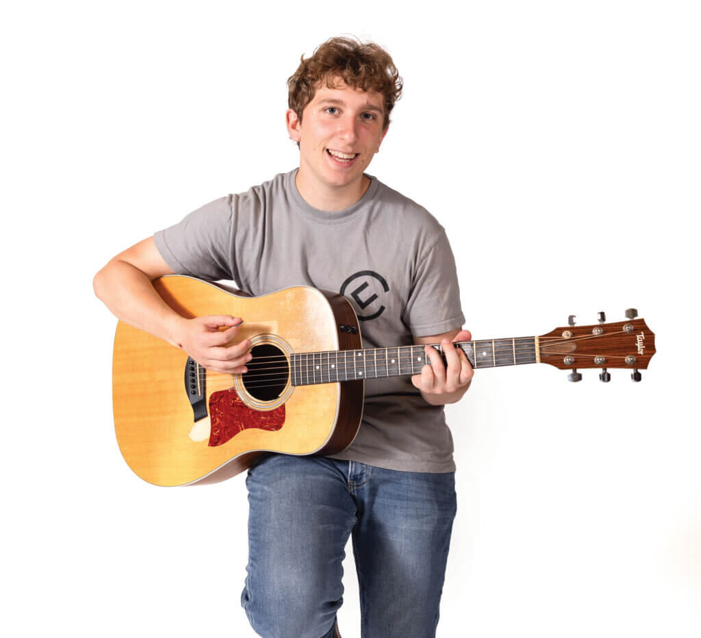 Elijah Elias playing an acoustic guitar