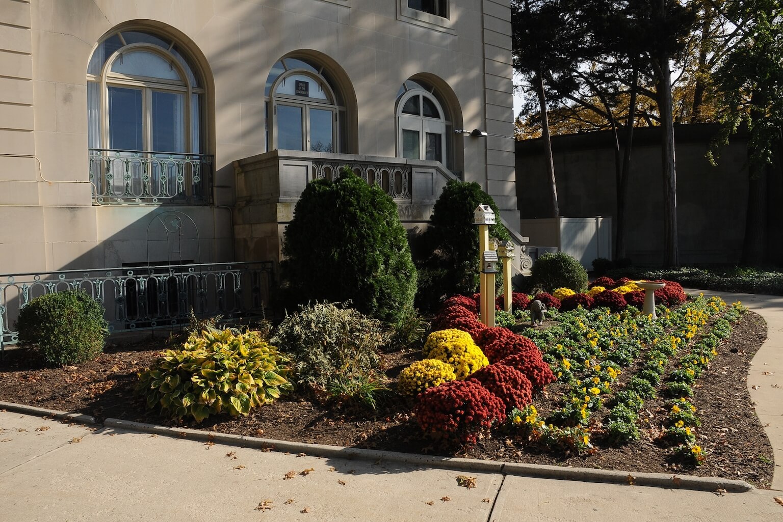 Wilson Hall Annex, with various yellow and red plants arranged outside