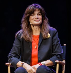 A photo of Carolyn Porco taking at a conference. 