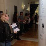 Photo shows audience members viewing the exhibit