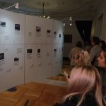 Photo shows audience members viewing exhibit