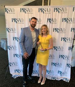 Photo of Michael Lauer, representing the award sponsor Johnson &amp; Johnson, presenting Monmouth University student Karalyn Hoover with the Future Public Relations Pro of the Year Award.