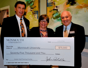 A group of three people holding up a large check with $75,000 written on it. 