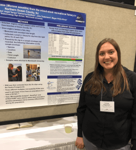 Carleigh Engstrom standing in front of a poster with detailed information. 