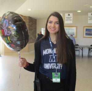 A photo of Taylor Ramiz holding a balloon that says thank you.