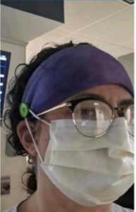 Photo shows person modeling special headbands that nursing students and faculty made and donated to ease discomfort from extended mask use.
