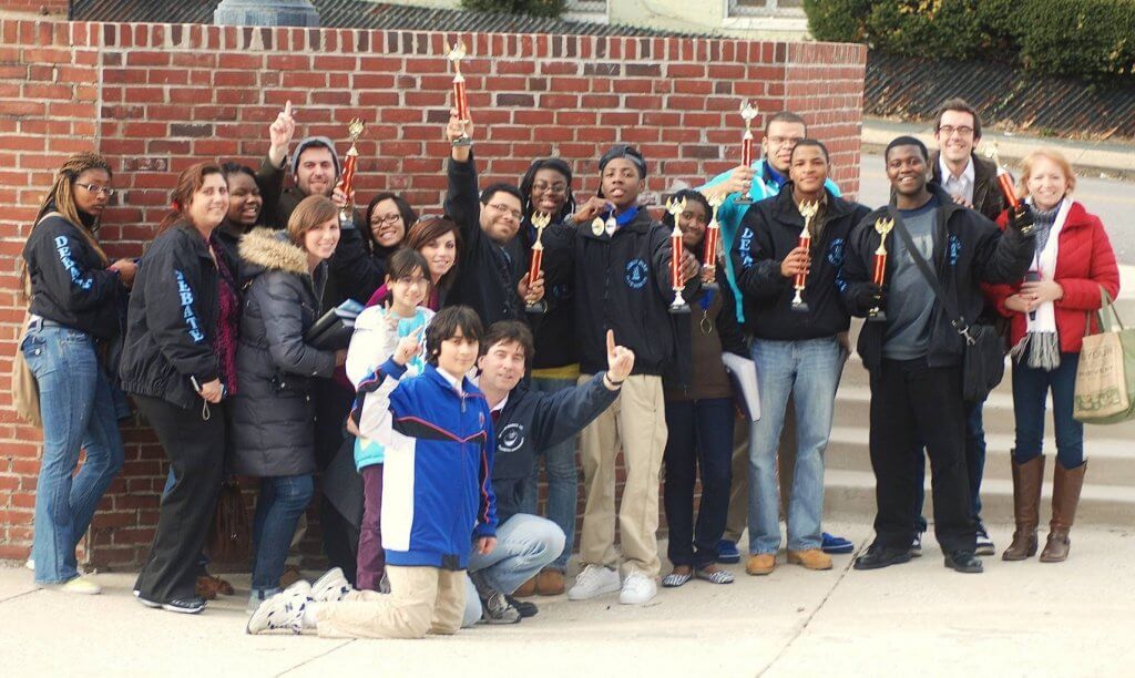 A group of people with some of them holding up trophies