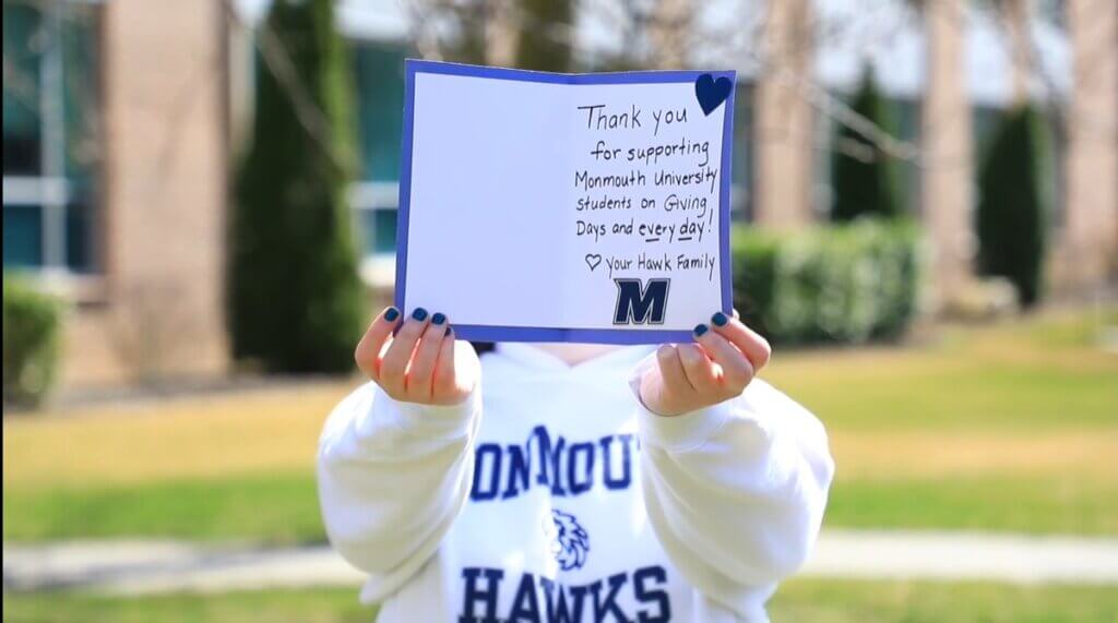 Student holding thank you card